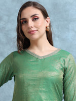 Load image into Gallery viewer, Woman wearing a green traditional outfit with a plain background
