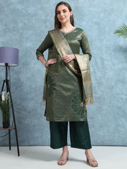Woman wearing a green traditional outfit with a matching dupatta against a light blue background
