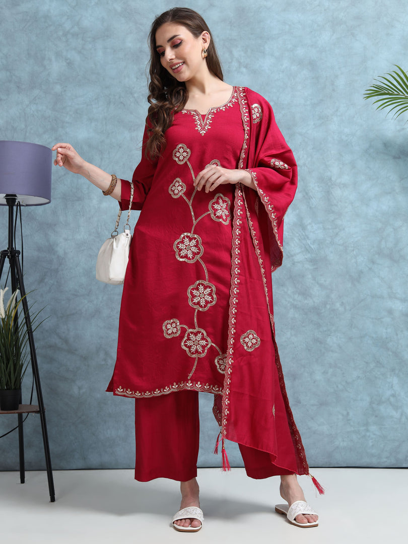 Woman wearing a red embroidered outfit with a white background