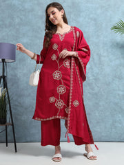 Woman wearing a red embroidered outfit with a white background