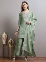 Load image into Gallery viewer, Woman wearing a green traditional outfit with a matching dupatta, standing against a plain background.